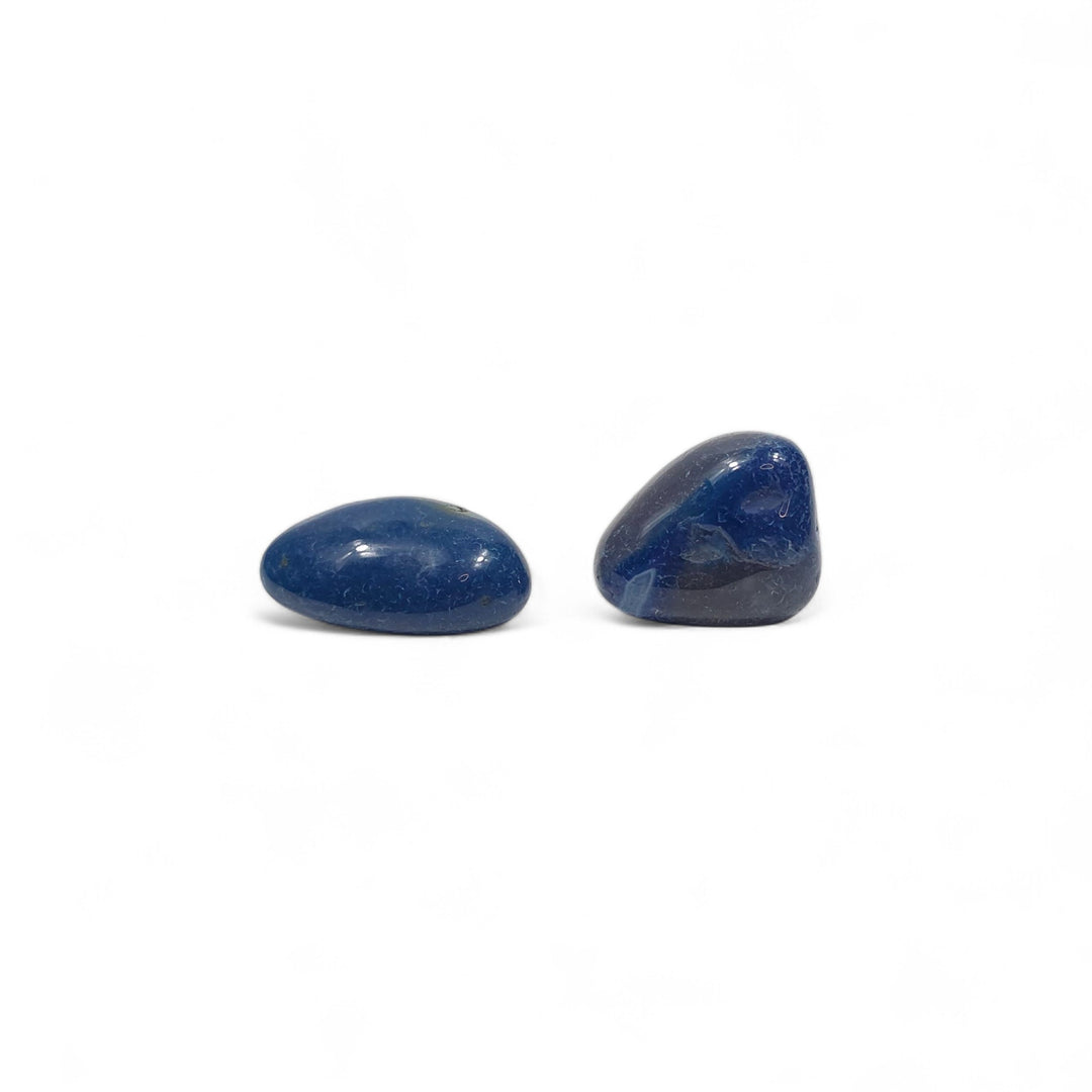 Deux Agates Bleues Teintées roulées côte à côte, illustrant les variations naturelles de teinte, de forme et de brillance.